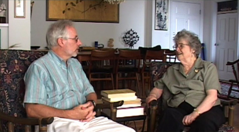 Photo of Henry McCarthy speaking with Beatrice Wright